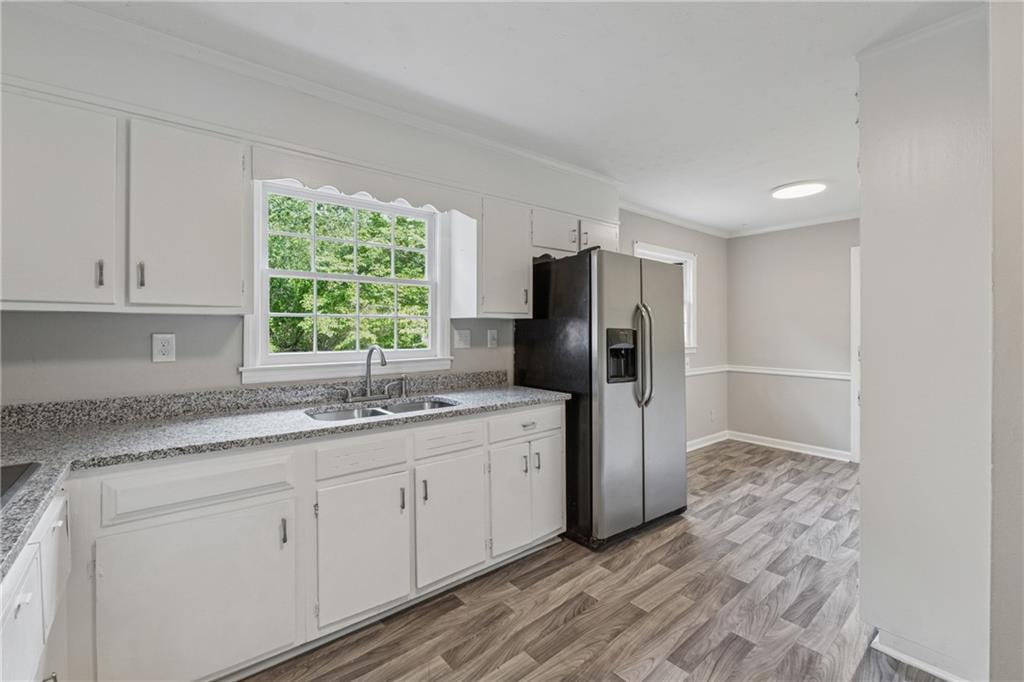 4616 Greensprings Road Atlanta, GA 30337 - Photo 8 of 26 a kitchen with stainless steel appliances granite countertop a refrigerator sink and cabinets