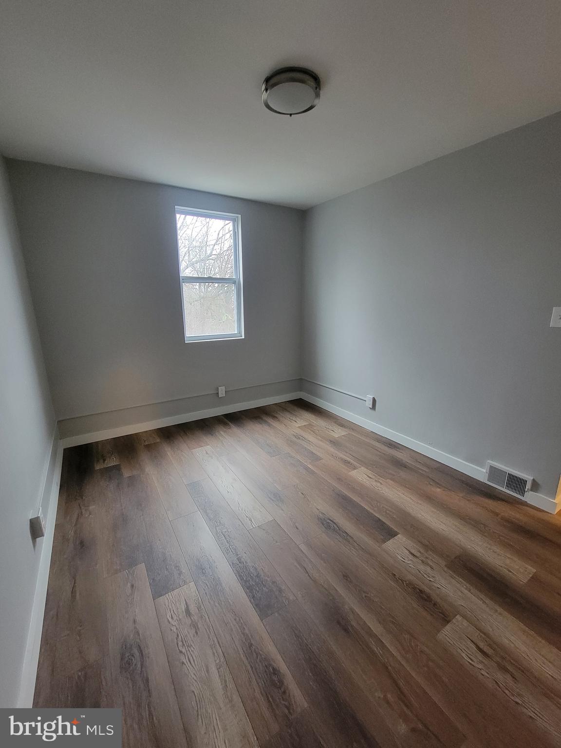 2896 Cushing Road Camden, NJ 08104 - Photo 18 of 31 an empty room with wooden floor and windows