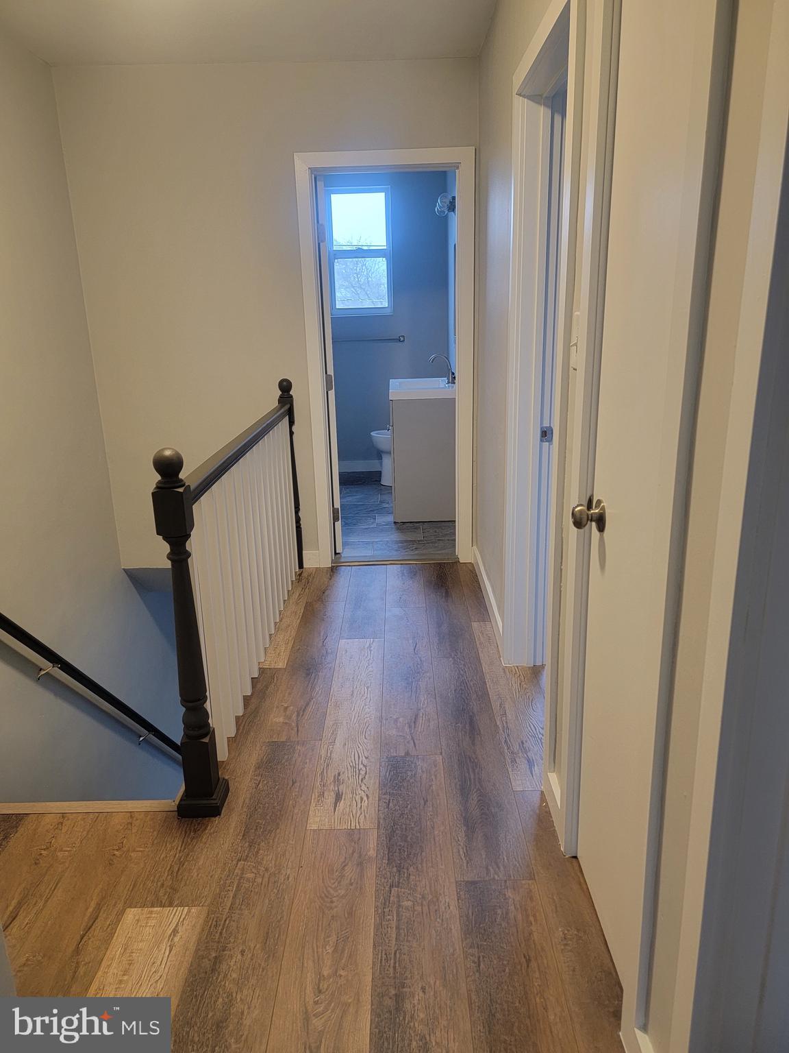 2896 Cushing Road Camden, NJ 08104 - Photo 19 of 31 a view of a hallway with wooden floor and stairs
