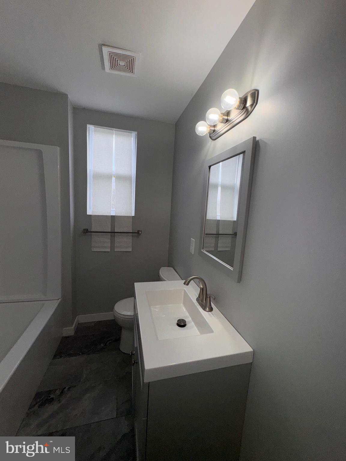 2896 Cushing Road Camden, NJ 08104 - Photo 20 of 31 a bathroom with a sink toilet and a mirror