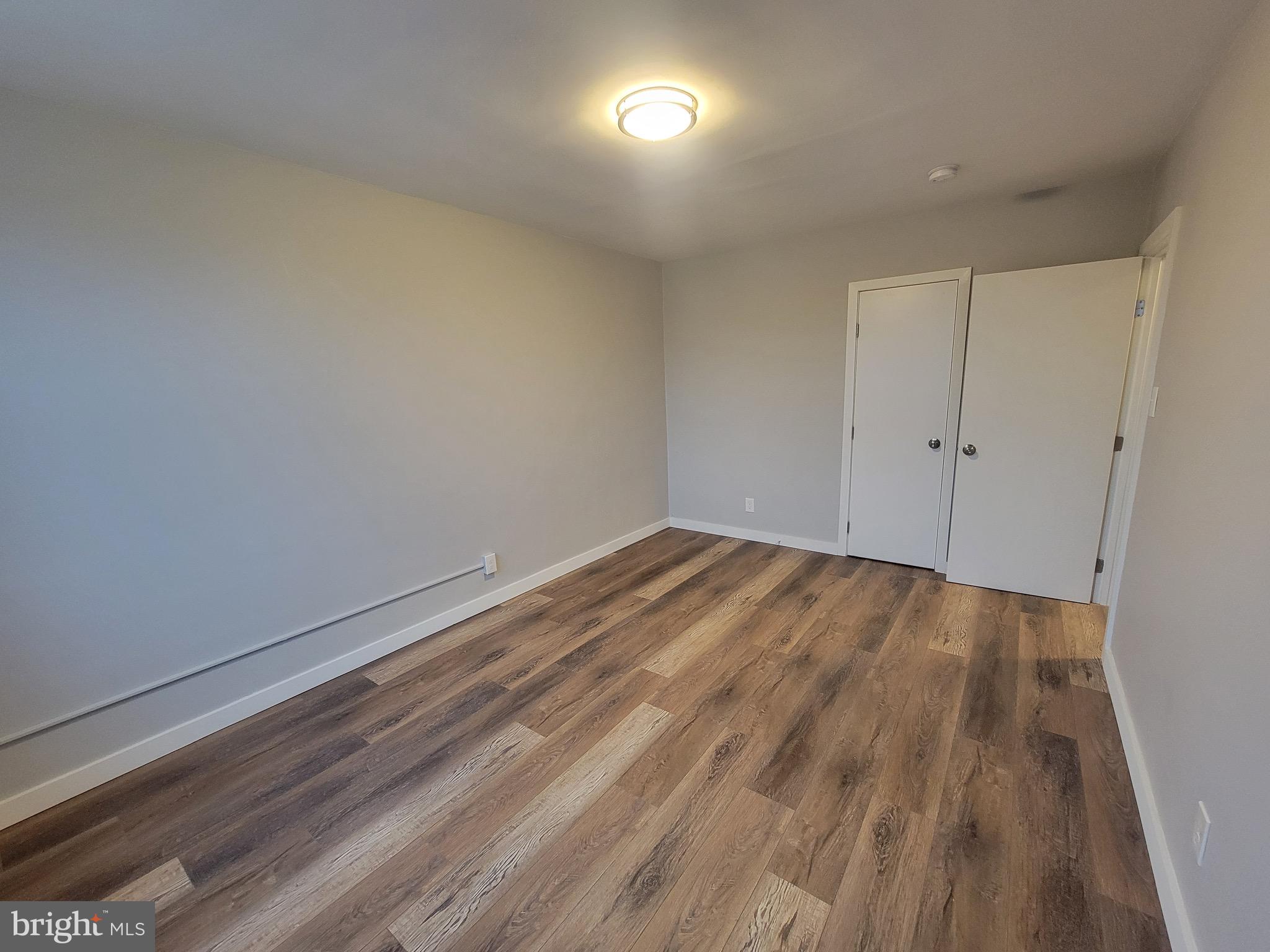 2896 Cushing Road Camden, NJ 08104 - Photo 24 of 31 a view of room with wooden floor and windows