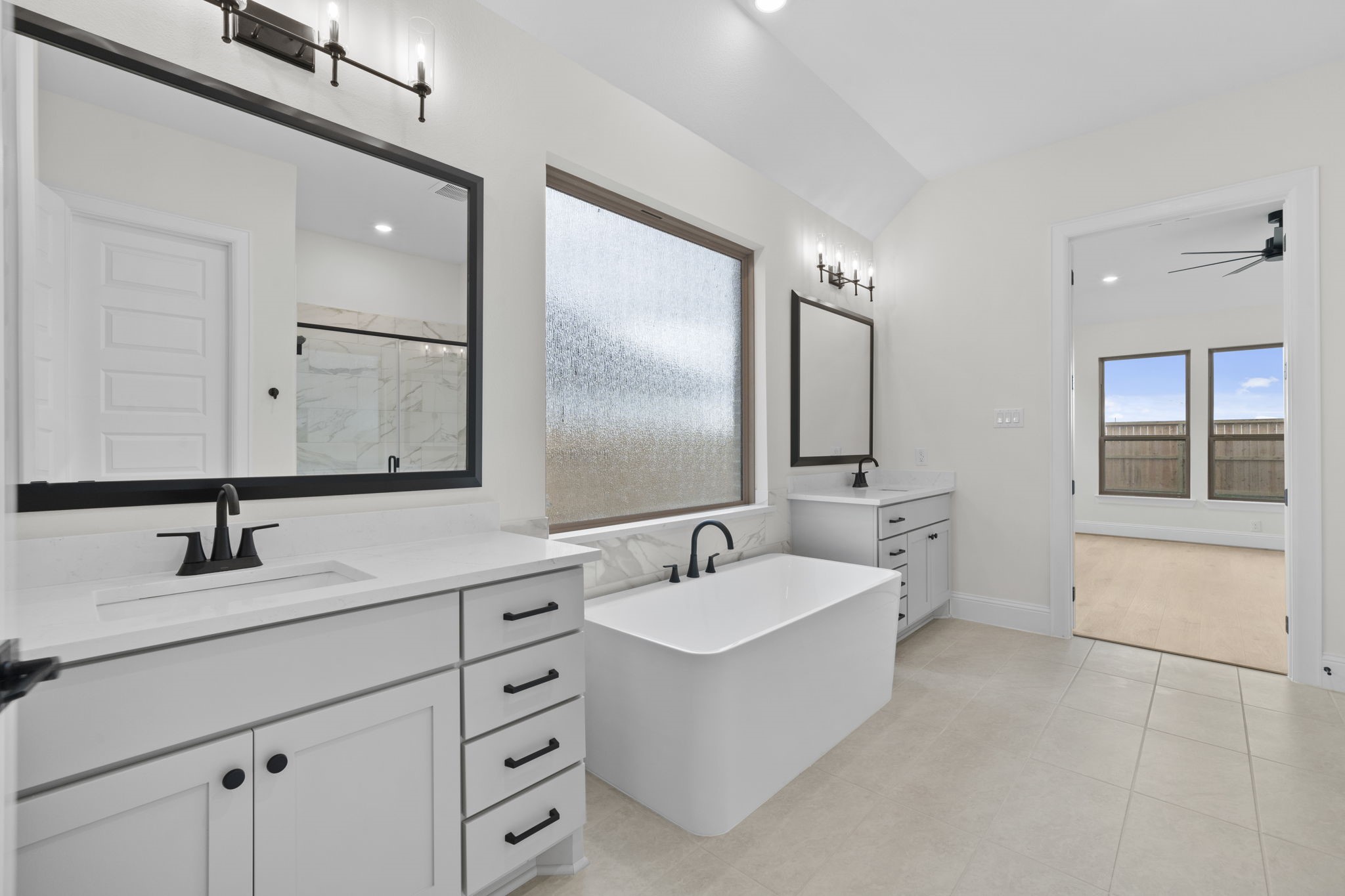 648 Cross Timbers Trace Hempstead, TX 77445 - Photo 25 of 40 a bathroom with double vanity sinks double vanity tub and a mirror