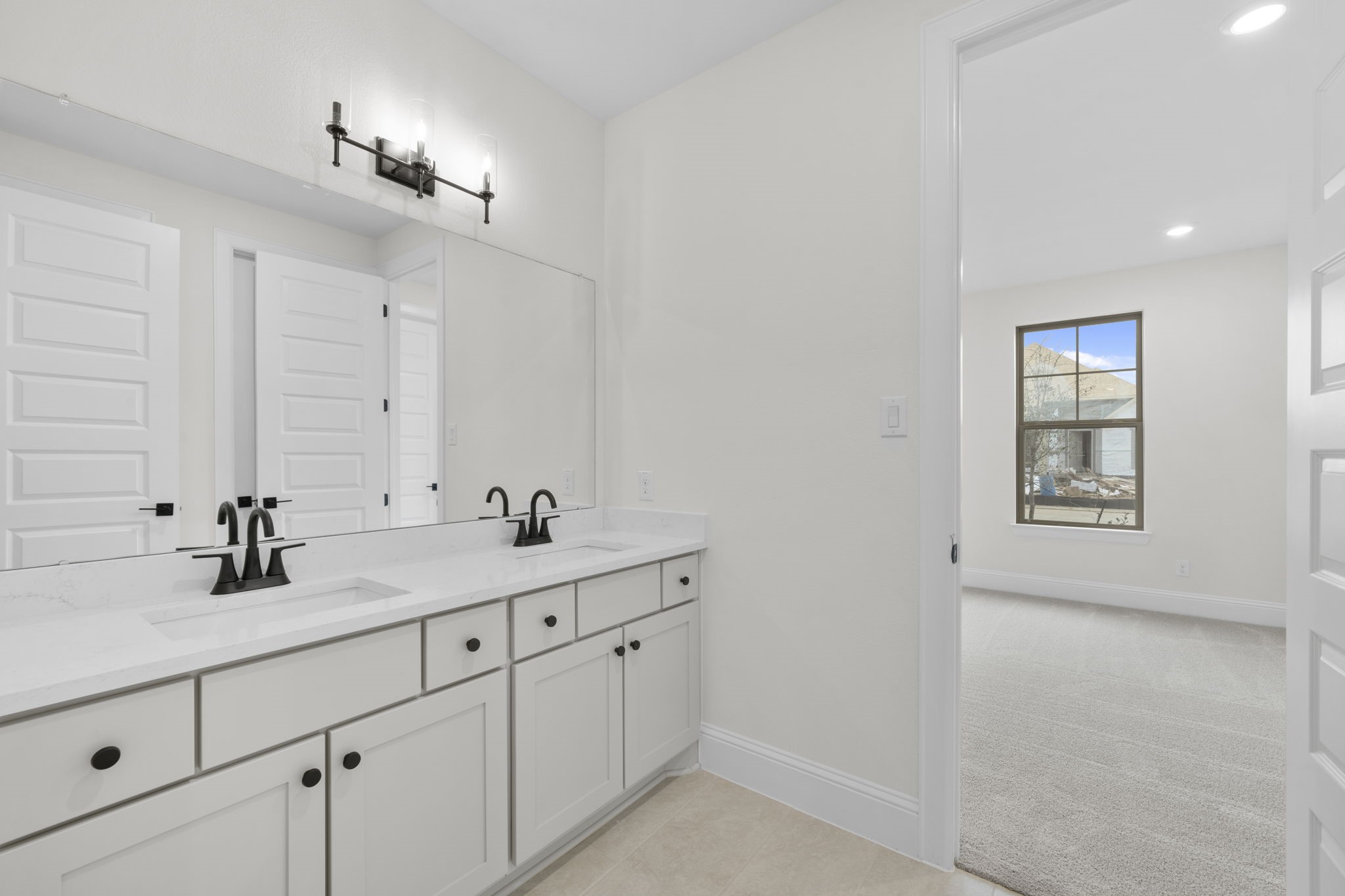 648 Cross Timbers Trace Hempstead, TX 77445 - Photo 10 of 40 a bathroom with 2 sink and a mirror