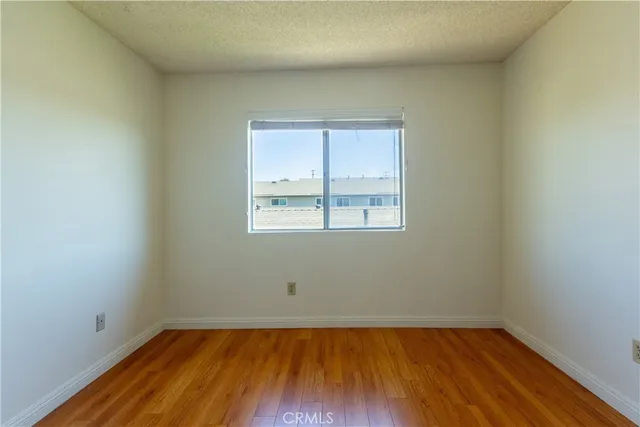 a view of a room with wooden floor and window