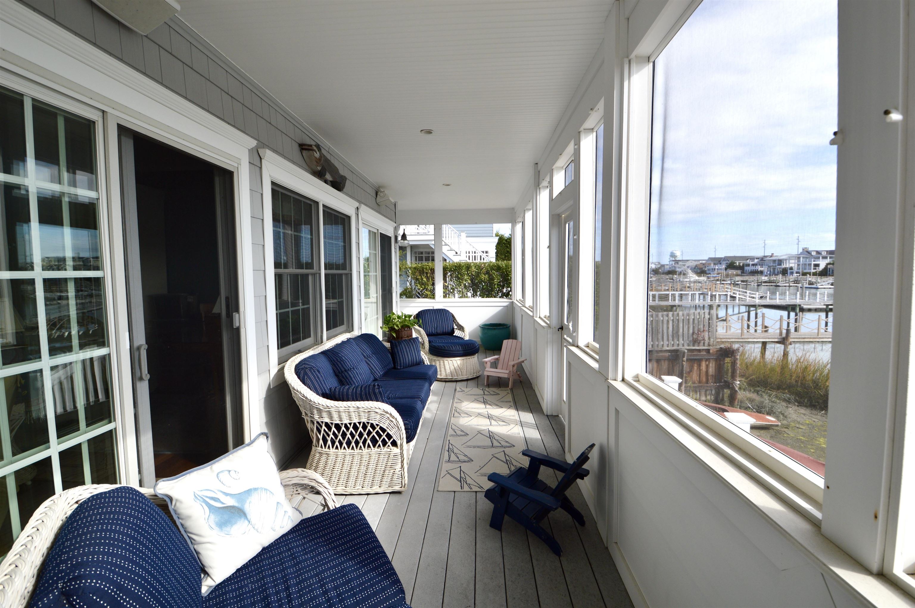 4765 4th Avalon, NJ 08202 - Photo 11 of 41 a living room with furniture and a floor to ceiling window