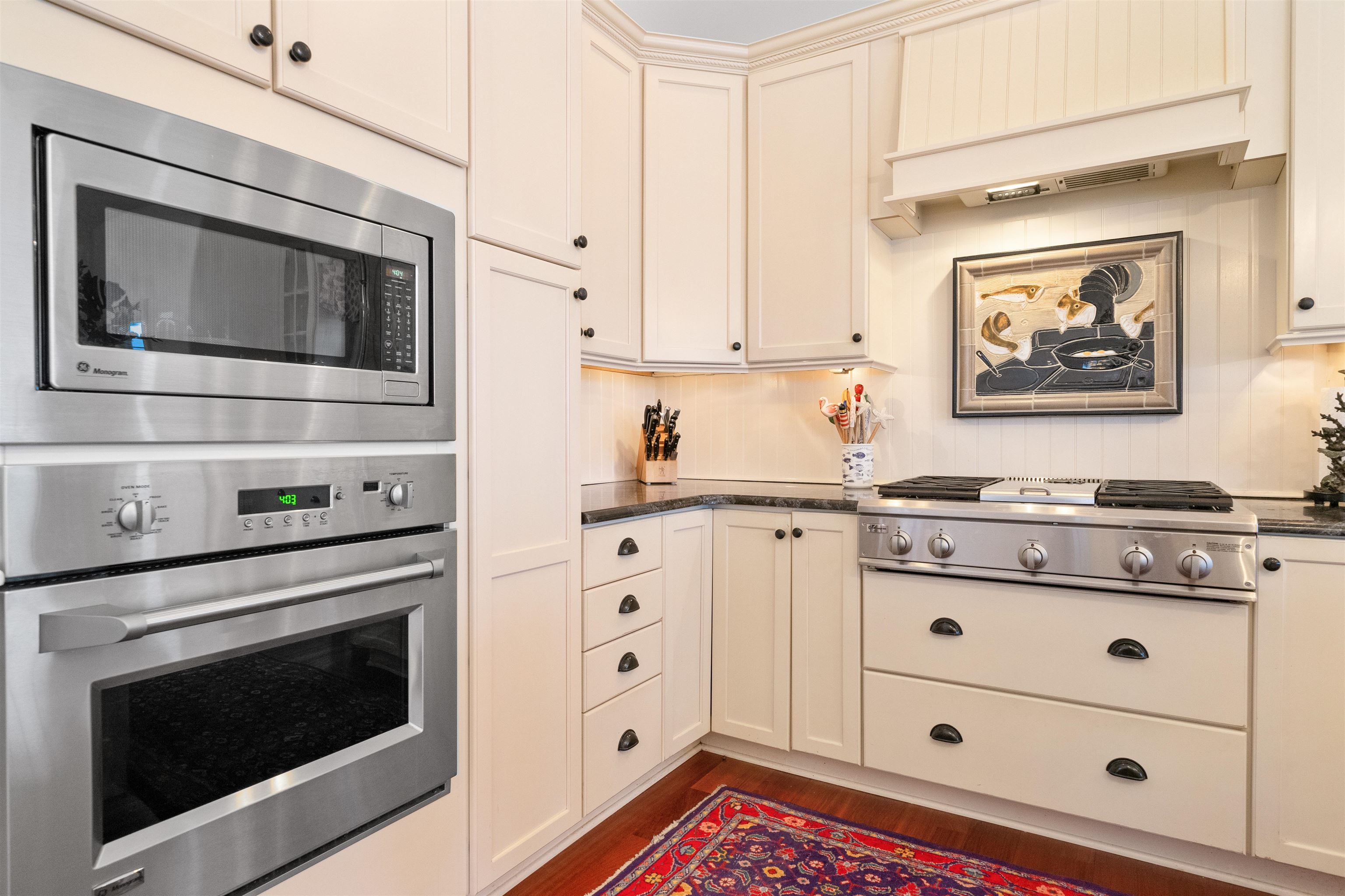 4765 4th Avalon, NJ 08202 - Photo 23 of 41 a kitchen with stainless steel appliances white cabinets and a stove a oven with wooden floor
