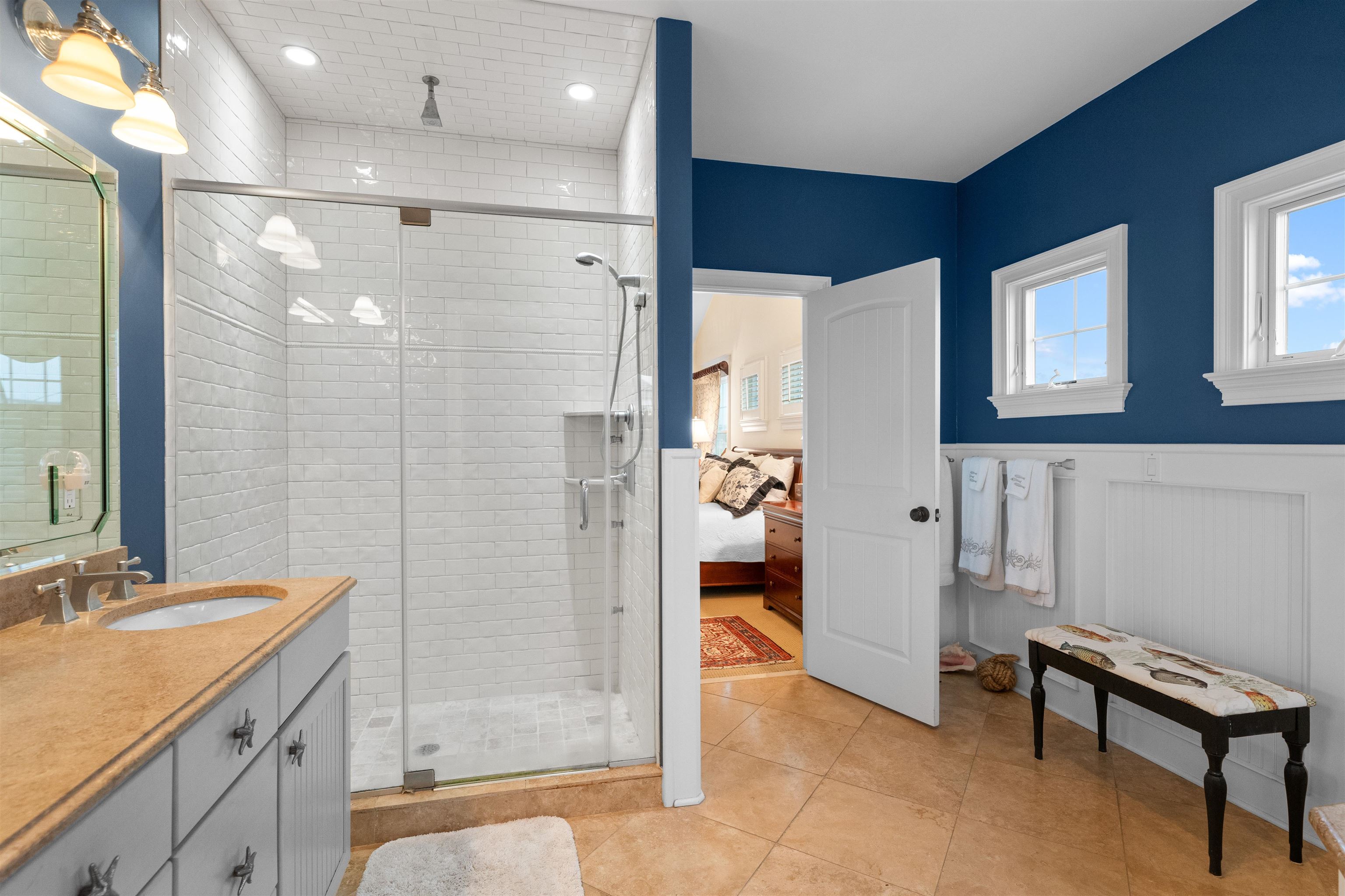 4765 4th Avalon, NJ 08202 - Photo 32 of 41 a bathroom with a shower sink and mirror