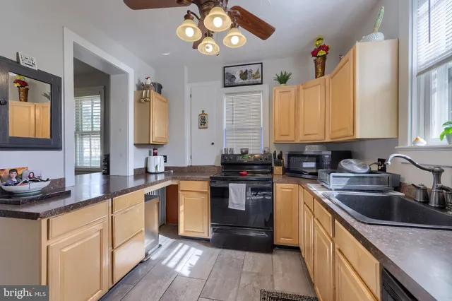 a kitchen with a sink cabinets and window
