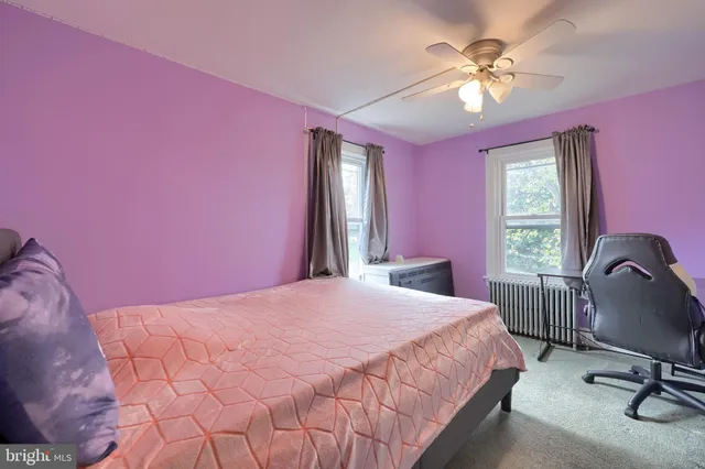 a bedroom with a bed dresser and a chair