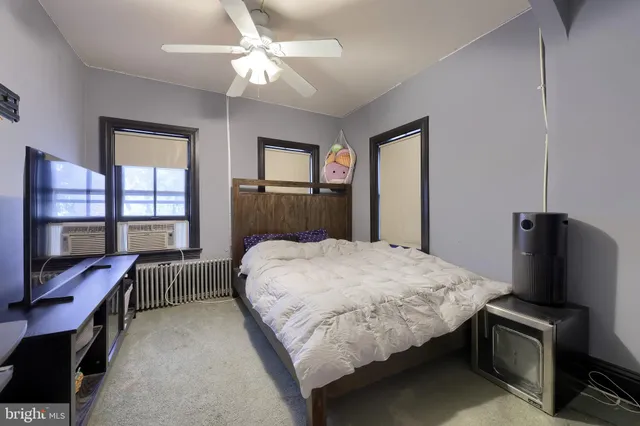 a bedroom with a bed chair and a window
