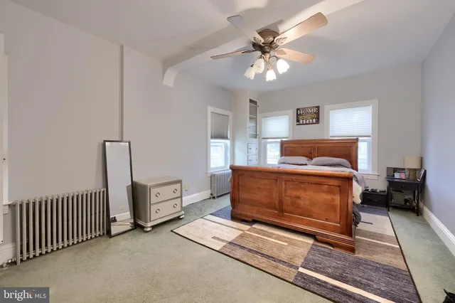 a bedroom with furniture and a chandelier