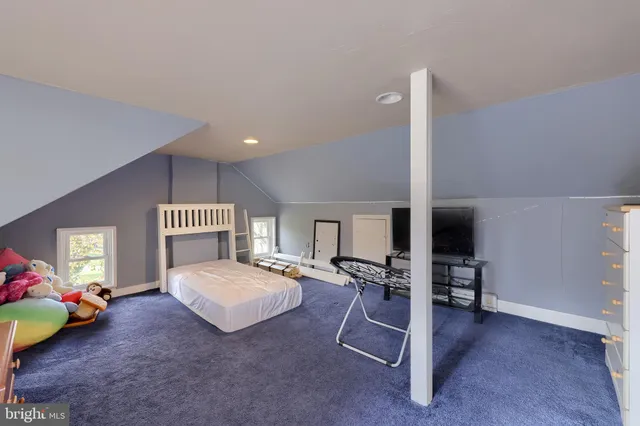 a spacious bedroom with a bed and a table in it