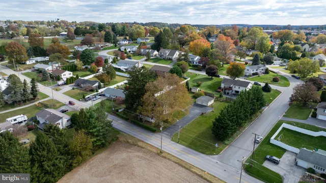an aerial view of residential houses with outdoor space and swimming pool