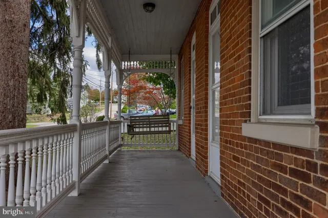 a view of a porch with a floor to ceiling window