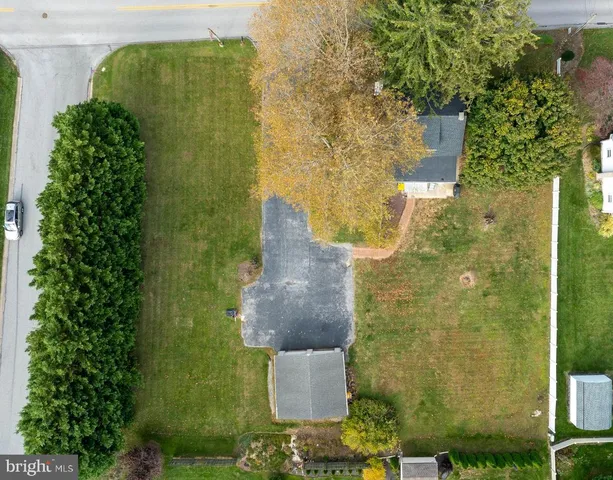 an aerial view of a residential houses with outdoor space