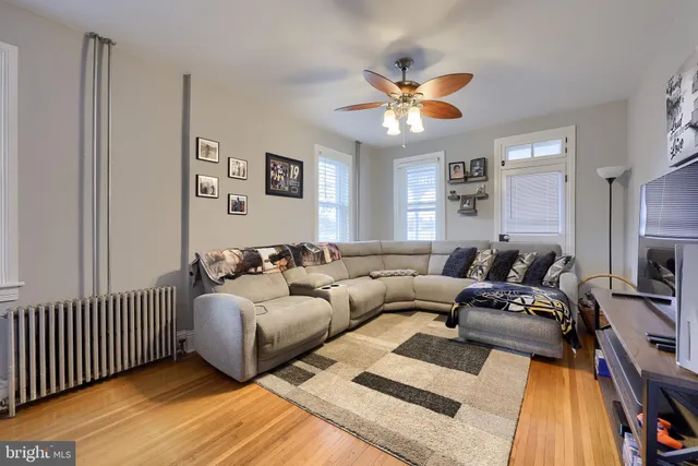 a living room with furniture and a chandelier