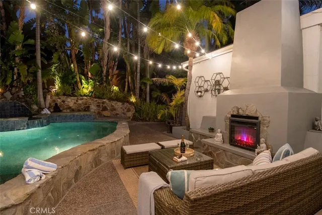 a living room with furniture a flat screen tv and a wall painting