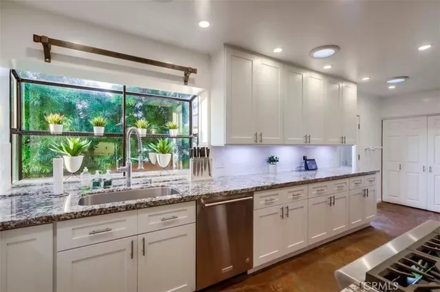a bedroom with bed and a chandelier