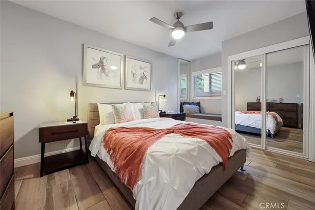 a bedroom with a bed and wooden floor