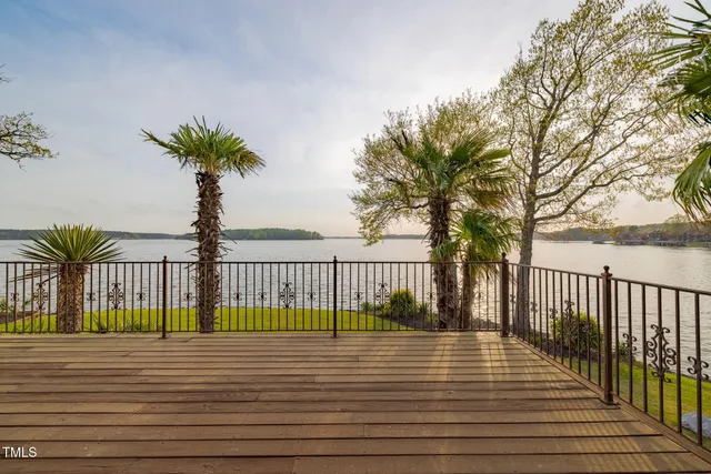 a front view of a house with a yard and potted plants