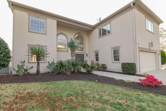 an aerial view of residential houses with outdoor space and swimming pool