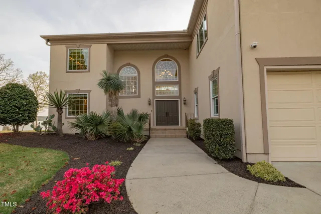 an aerial view of a house with swimming pool patio and lake view