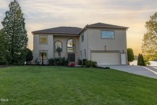 an aerial view of residential houses with outdoor space and lake view