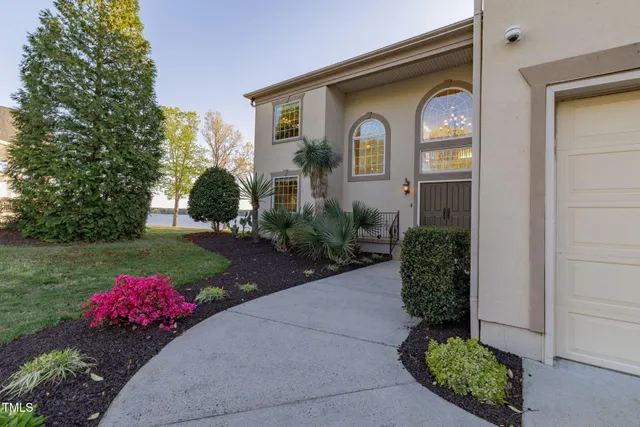 a front view of a house with a garden