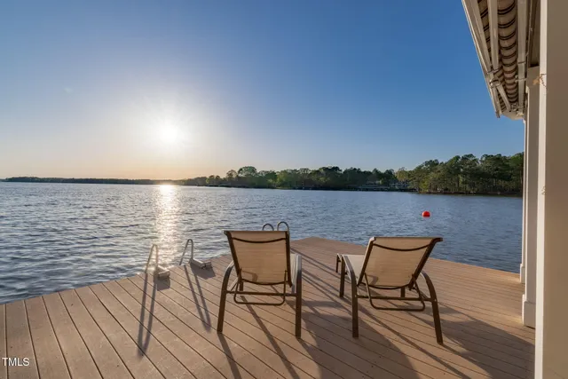 a view of a balcony with wooden floor and potted plants