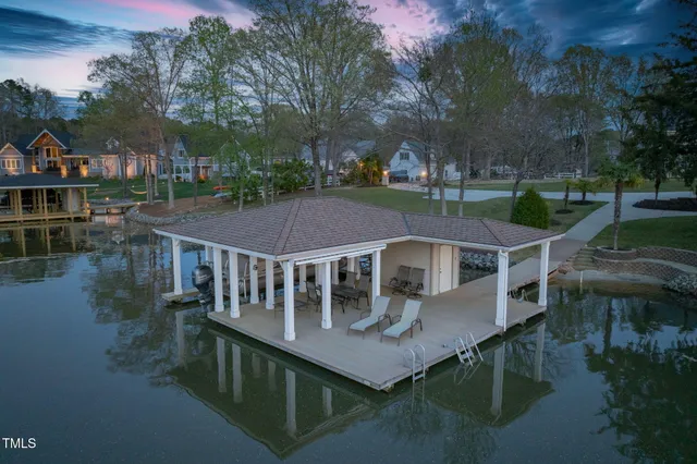 a living room with fireplace furniture and floor to ceiling windows