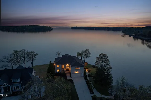 a living room with furniture a fireplace and a floor to ceiling window