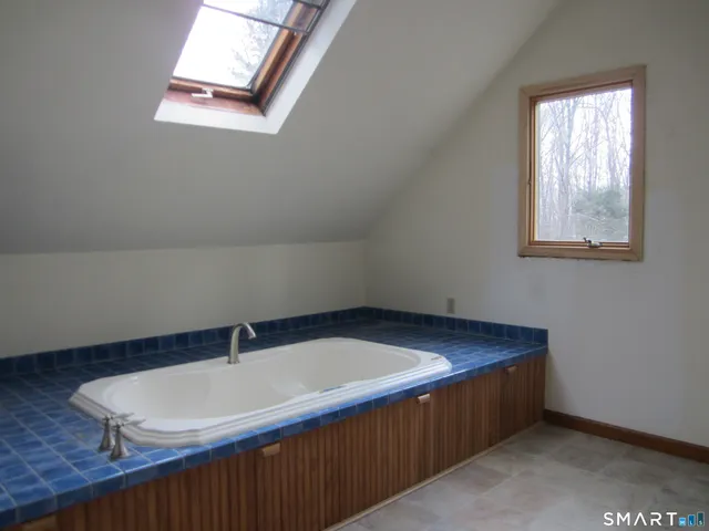 a room with a sink cabinets and a window
