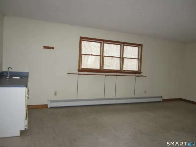 an empty room with a empty space and window