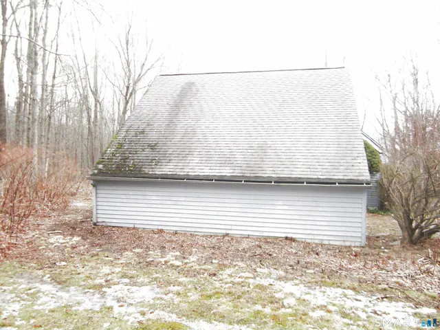 a view of a dry yard with wooden fence