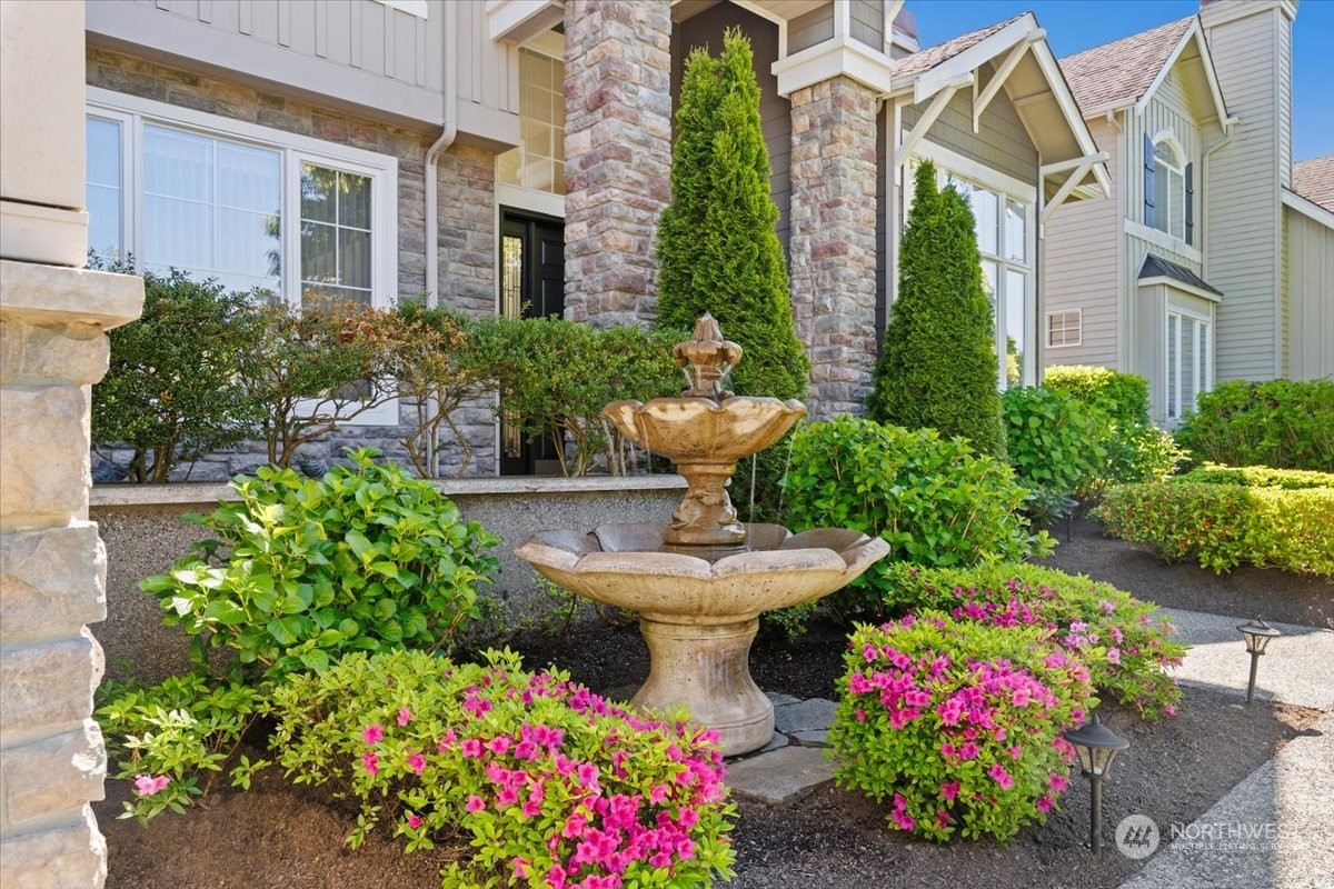 3808 209th Place Southeast Bothell, WA 98021 - Photo 3 of 5 a view of a fountain in front of brick house