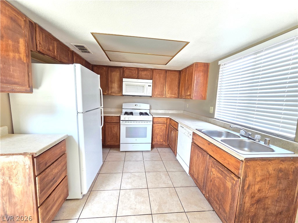 2882 Sandyfalls Way Las Vegas, NV 89142 - Photo 4 of 18 A well-equipped kitchen features ample cabinetry and a practical U-shaped counter layout.