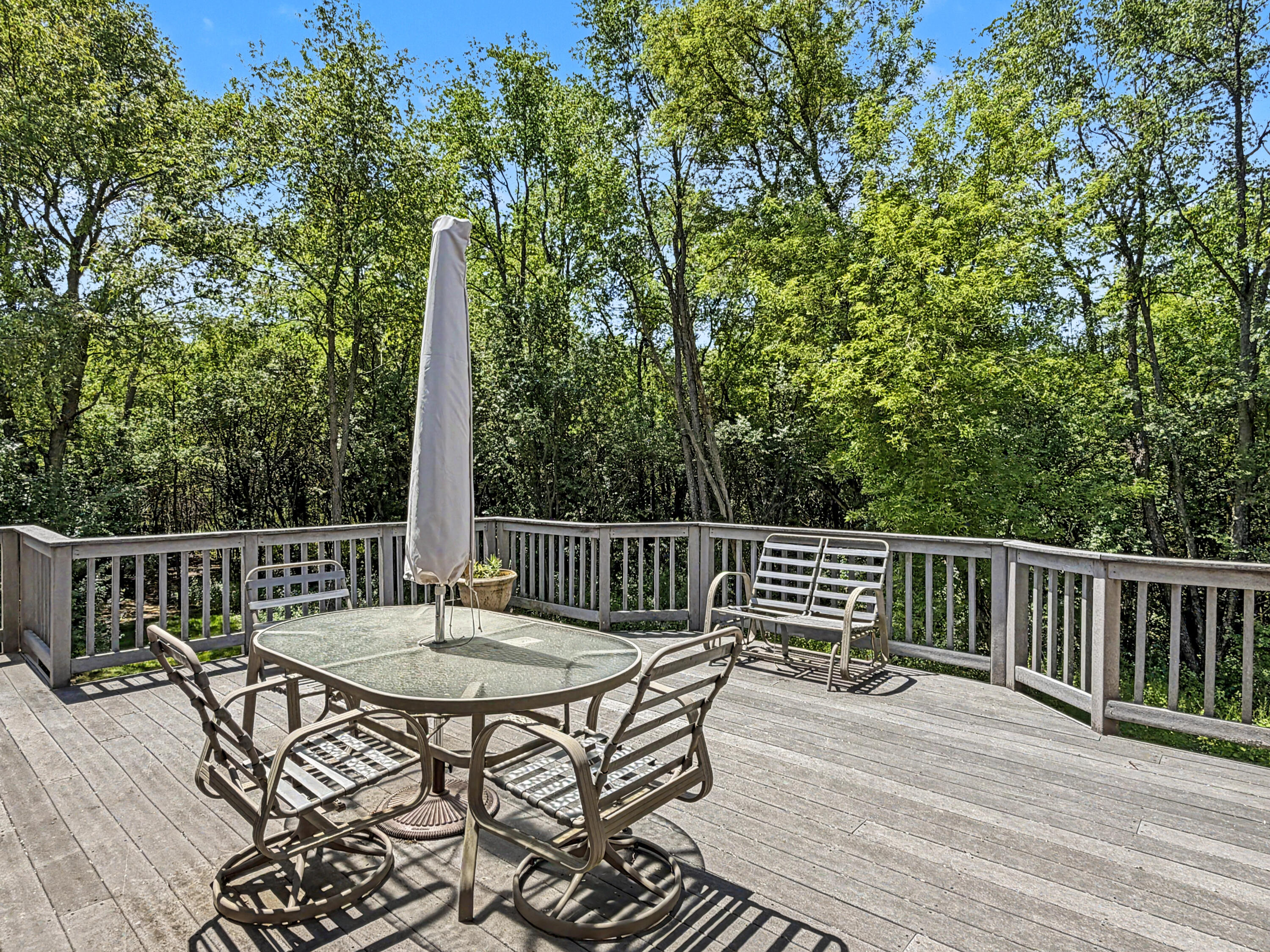 W291-s5245 Ridgefield Road Waukesha, WI 53189 - Photo 43 of 44 Spacious 32’ x 16’ composite deck just off the sunroom, overlooking the private wooded setting.