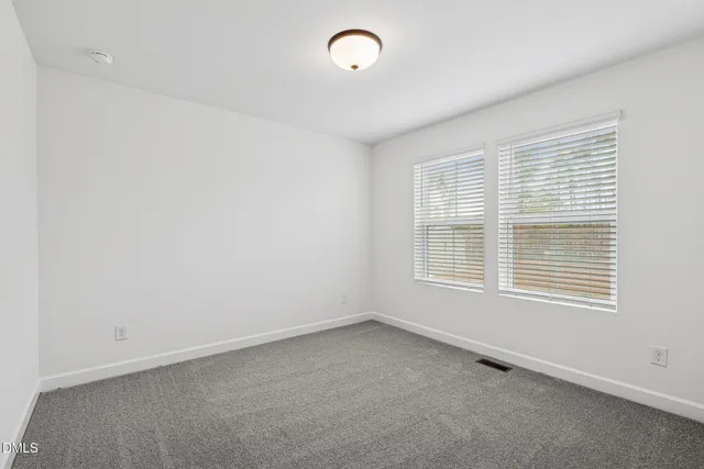 a view of an empty room with closet area