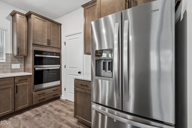 a kitchen with stainless steel appliances a refrigerator and cabinets