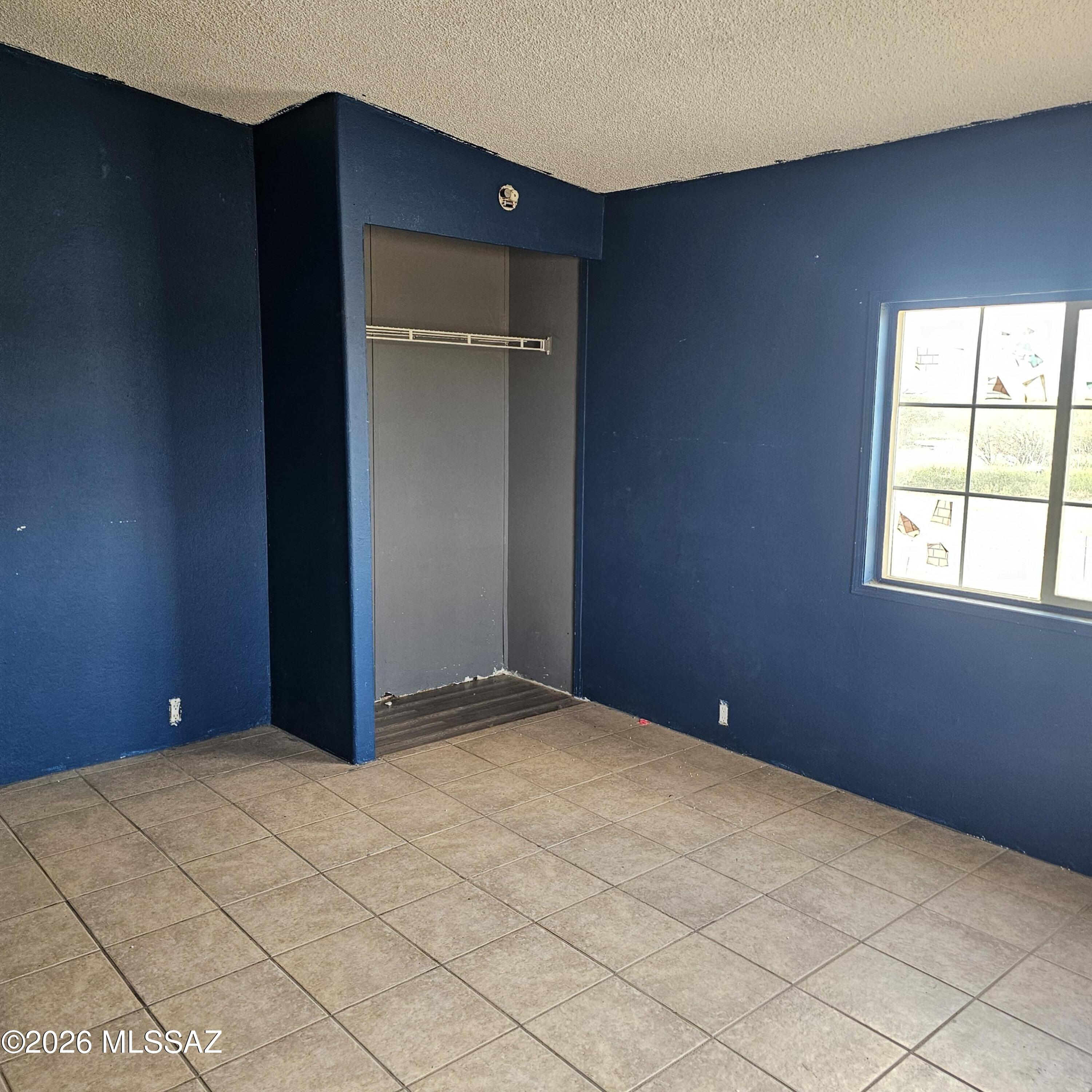 14020 West Park Road Tucson, AZ 85735 - Photo 13 of 18 a view of an empty room with window and wooden floor
