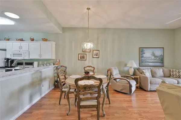 a living room with furniture a flat screen tv and a large window