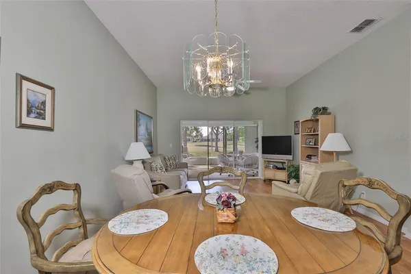 a view of a dining room with furniture and chandelier