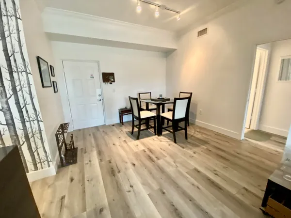 a view of a dining room with furniture and wooden floor