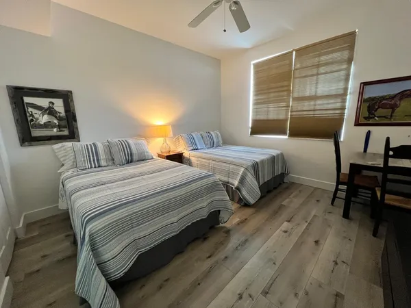 a bedroom with two beds and a flat screen tv