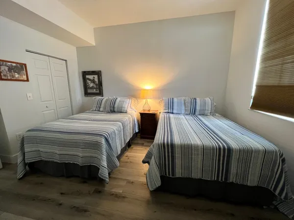 a bedroom with a bed and a night stand