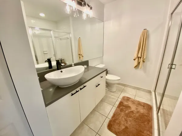 a bathroom with a sink a toilet and a mirror