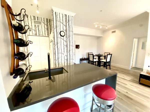 a view of a room with furniture and wooden floor