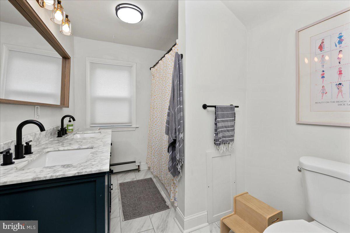 1708 Wrightfield Road Yardley, PA 19067 - Photo 27 of 41 a bathroom with a sink and mirror with toilet
