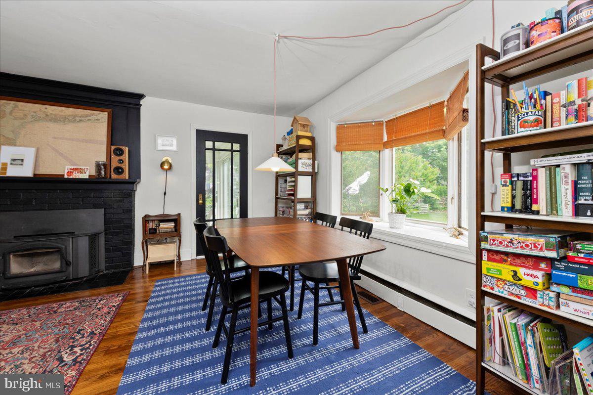 1708 Wrightfield Road Yardley, PA 19067 - Photo 8 of 41 a dining room with furniture a book shelves and wooden floor