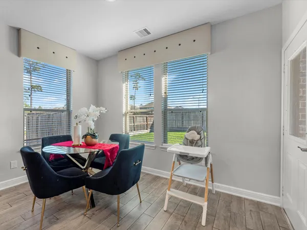 a dining room with furniture and window